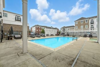Sparkling pool with sundeck, hot tub, and grilling area